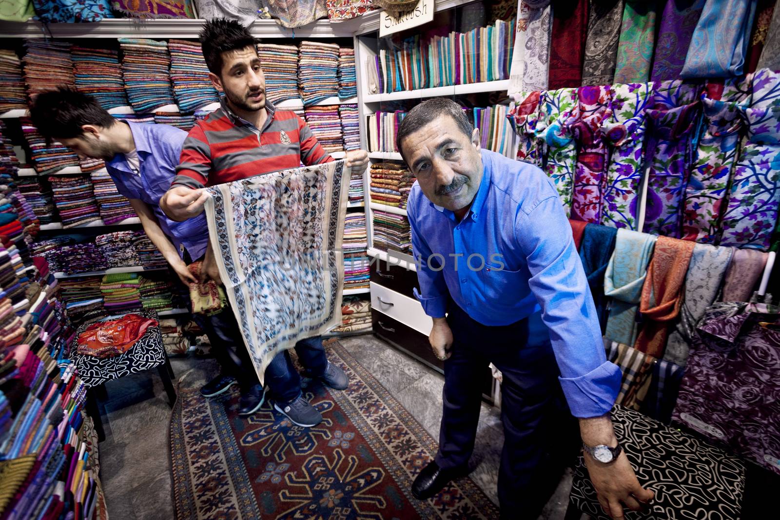 ISTANBUL, TURKEY – APRIL 26: Fabric merchant and sons inside the Grand Bazaar in Istanbul prior to Anzac Day on April 26, 2012 in Istanbul, Turkey. 