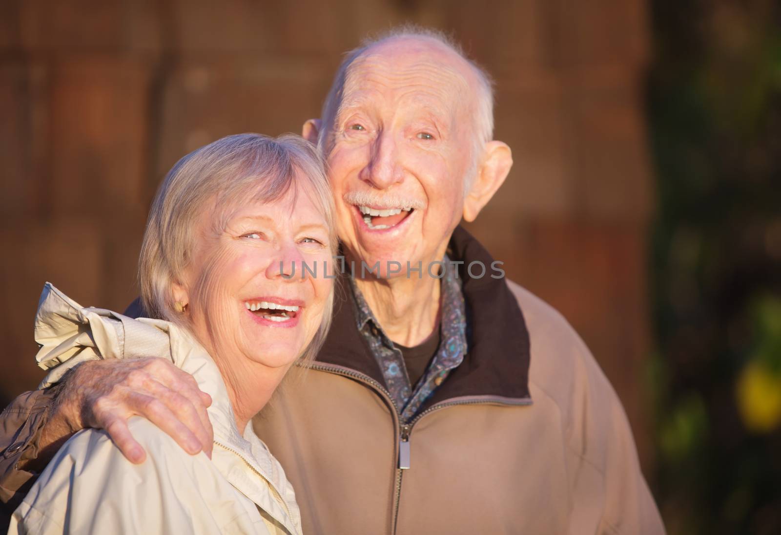 Cute Caucasian mature couple laughing together outdoors