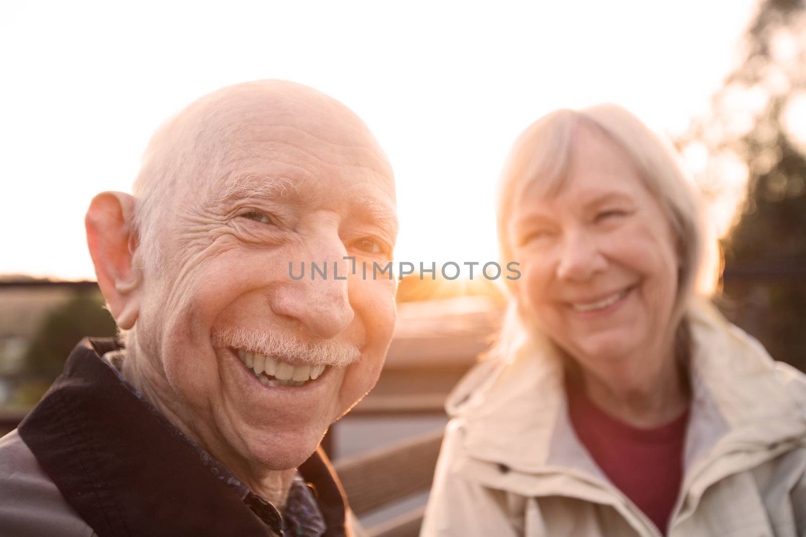 Cute Caucasian couple sitting together outdoors