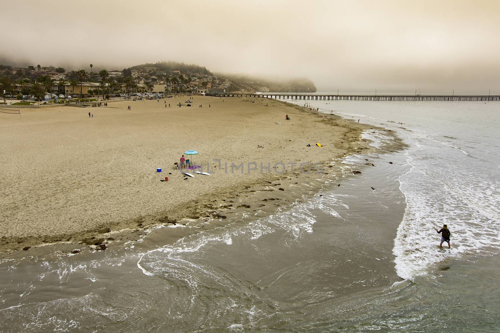 Fog receding as morning activity picks up at Avila Beach in California