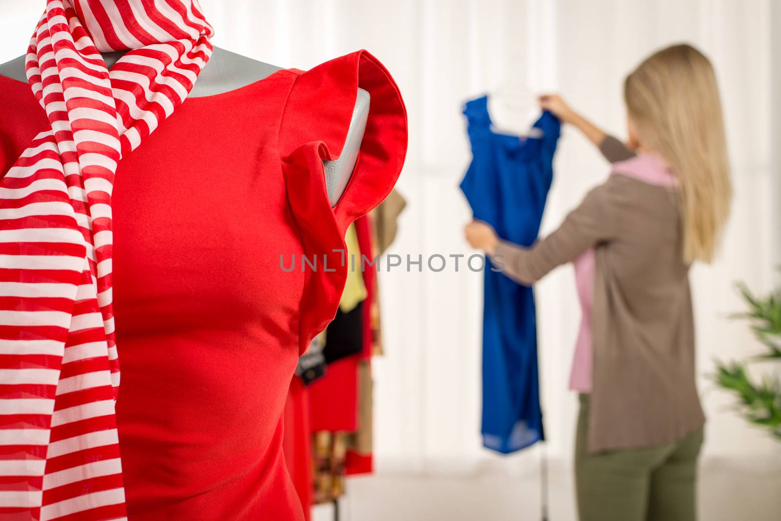 Close-up of a dress on mannequin in fashion designer office.