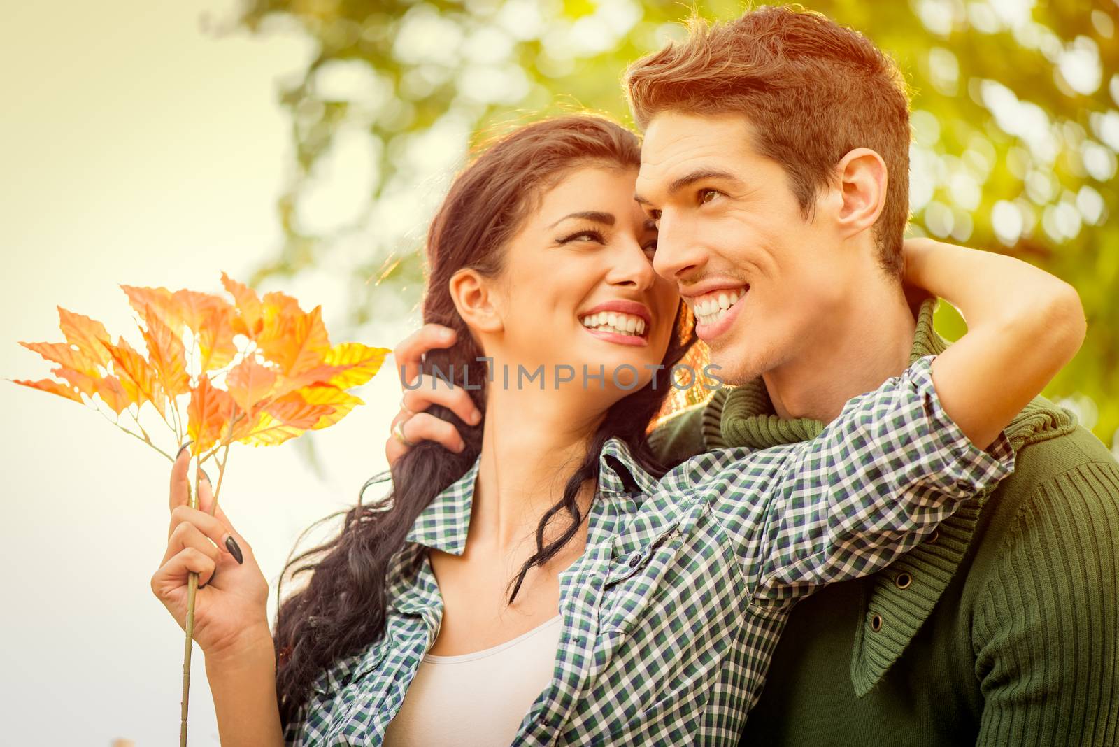 Close-up of a young embraced heterosexual couple with a smile.