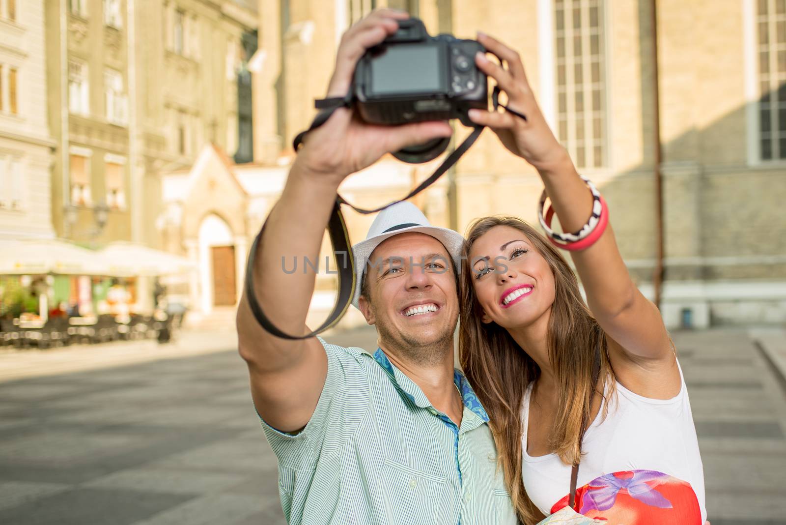 Happy tourists taking photo of themselves