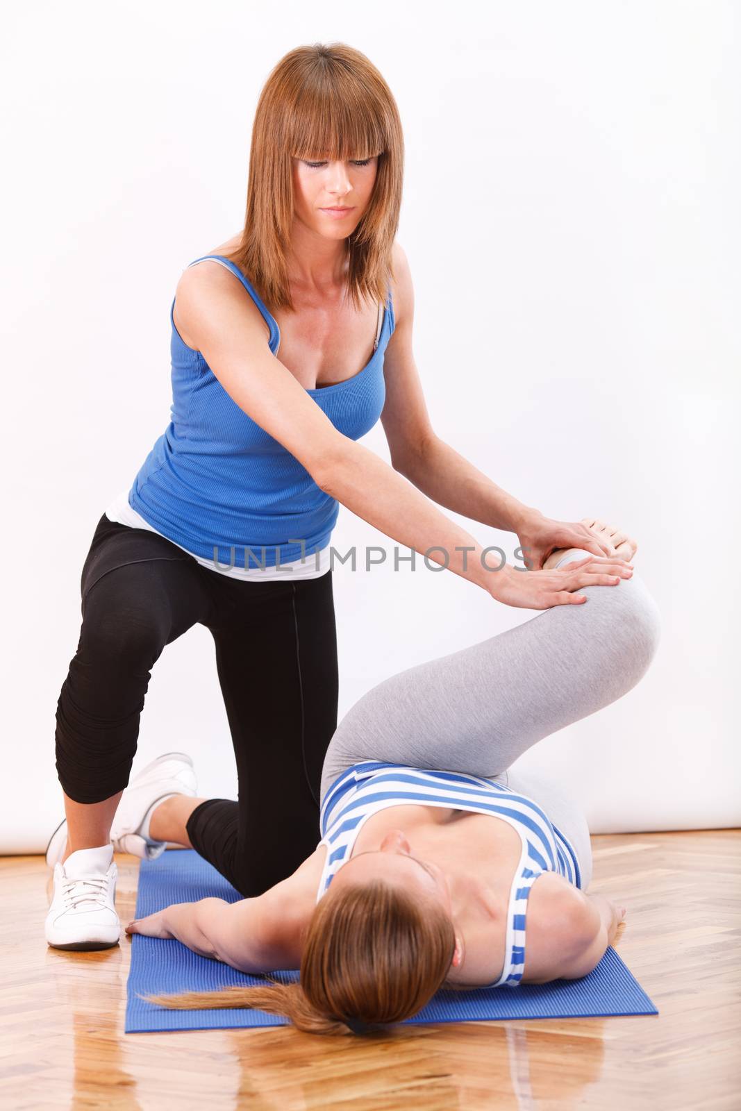 young woman stretching With fitness instructor