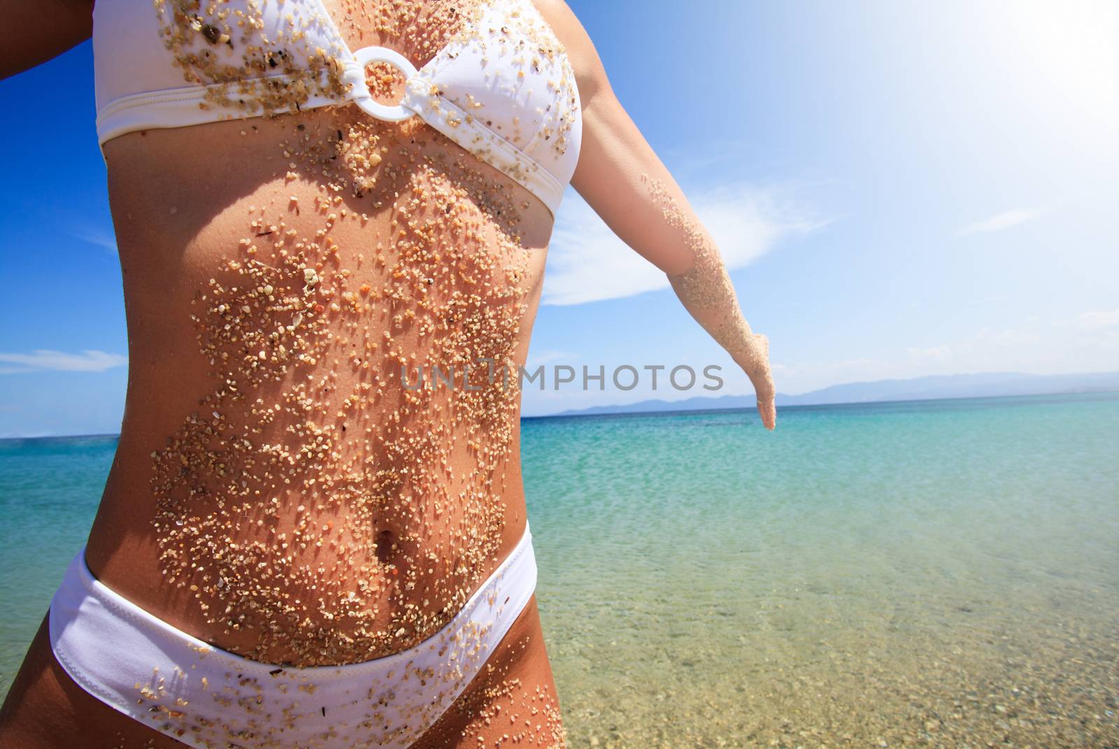 Woman body covered with sand