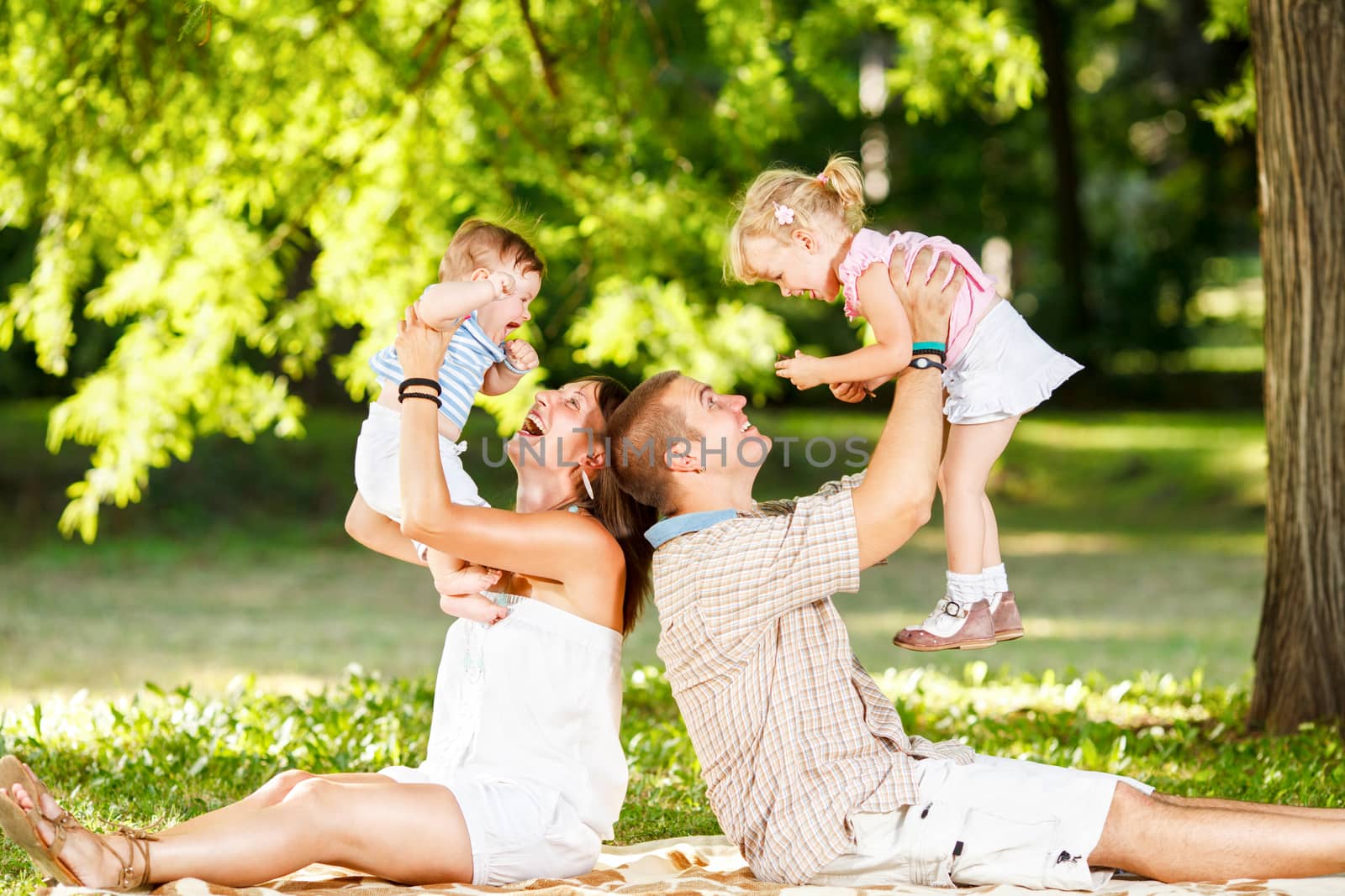 Family Playing In The Park by MilanMarkovic78