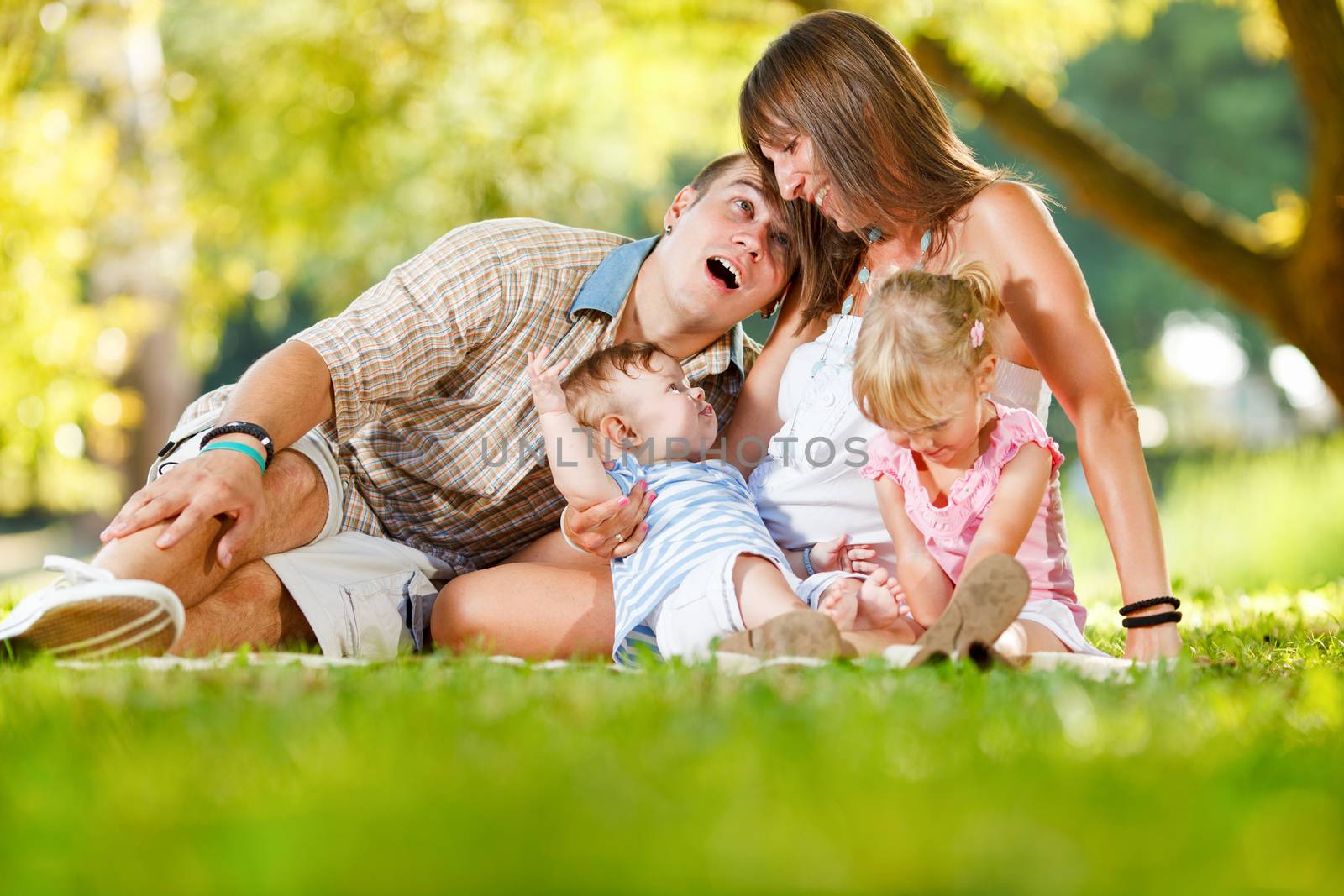 Beautiful happy family enjoying in the park