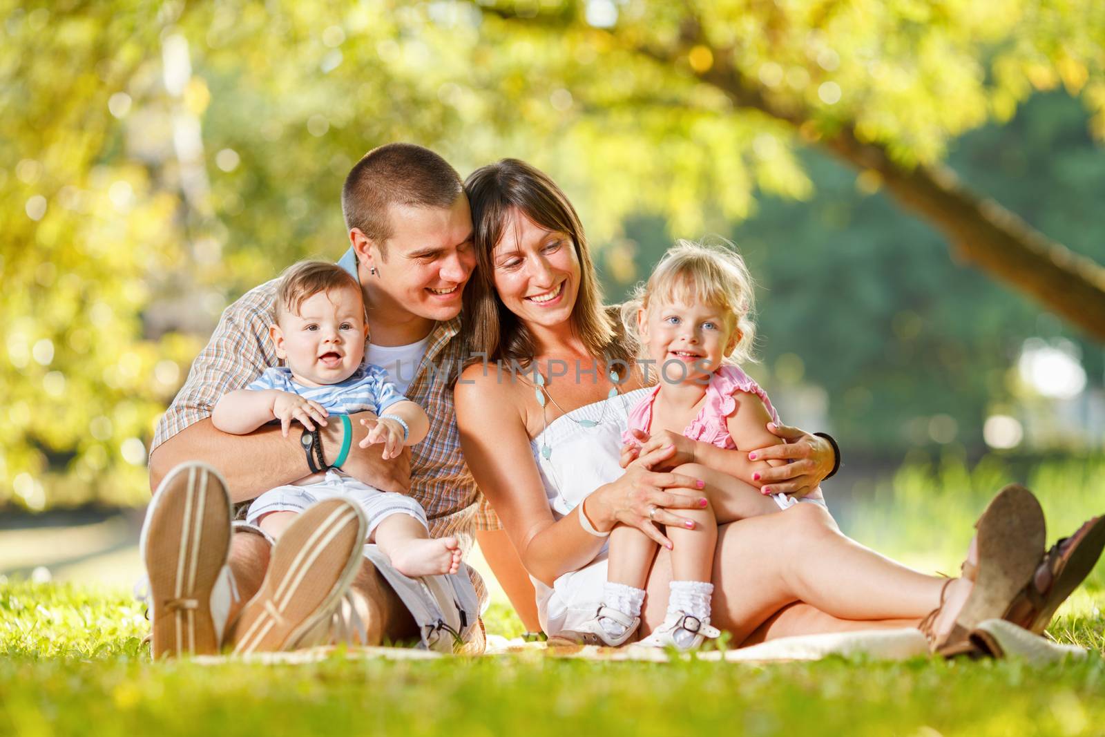 Beautiful happy family enjoying in the park