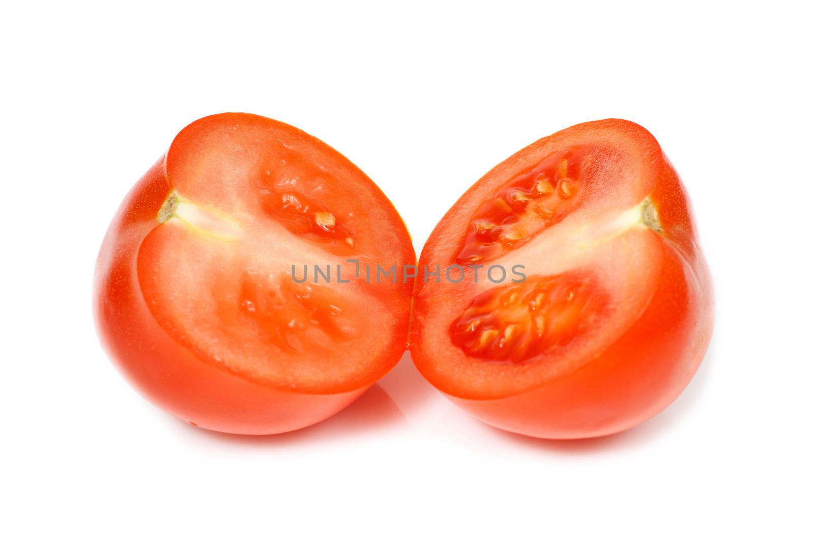Organic beautiful red halved tomato. White background.