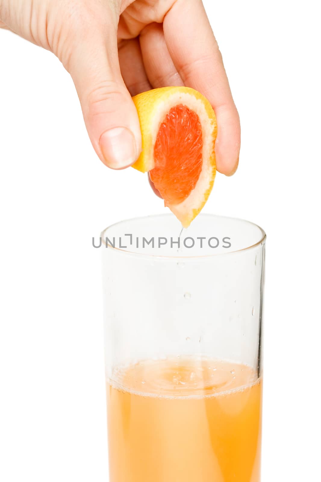 Making freshly squeezed grapefruit juice. White background