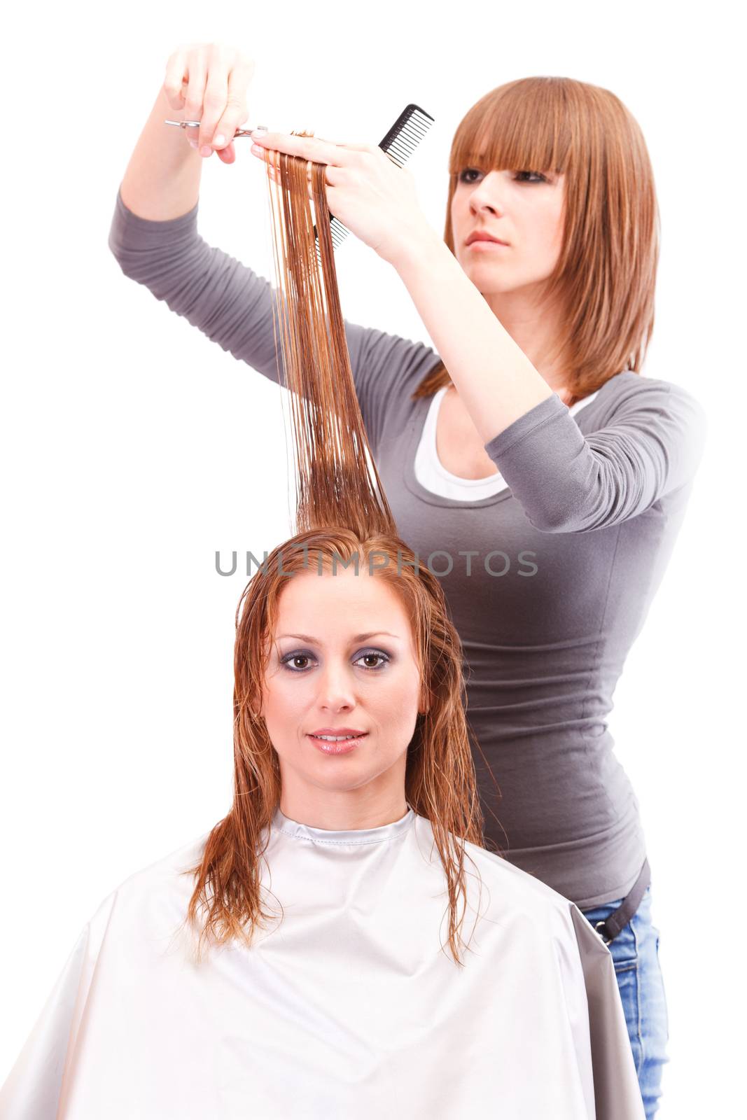 Hairdresser cutting the hair of a blonde woman