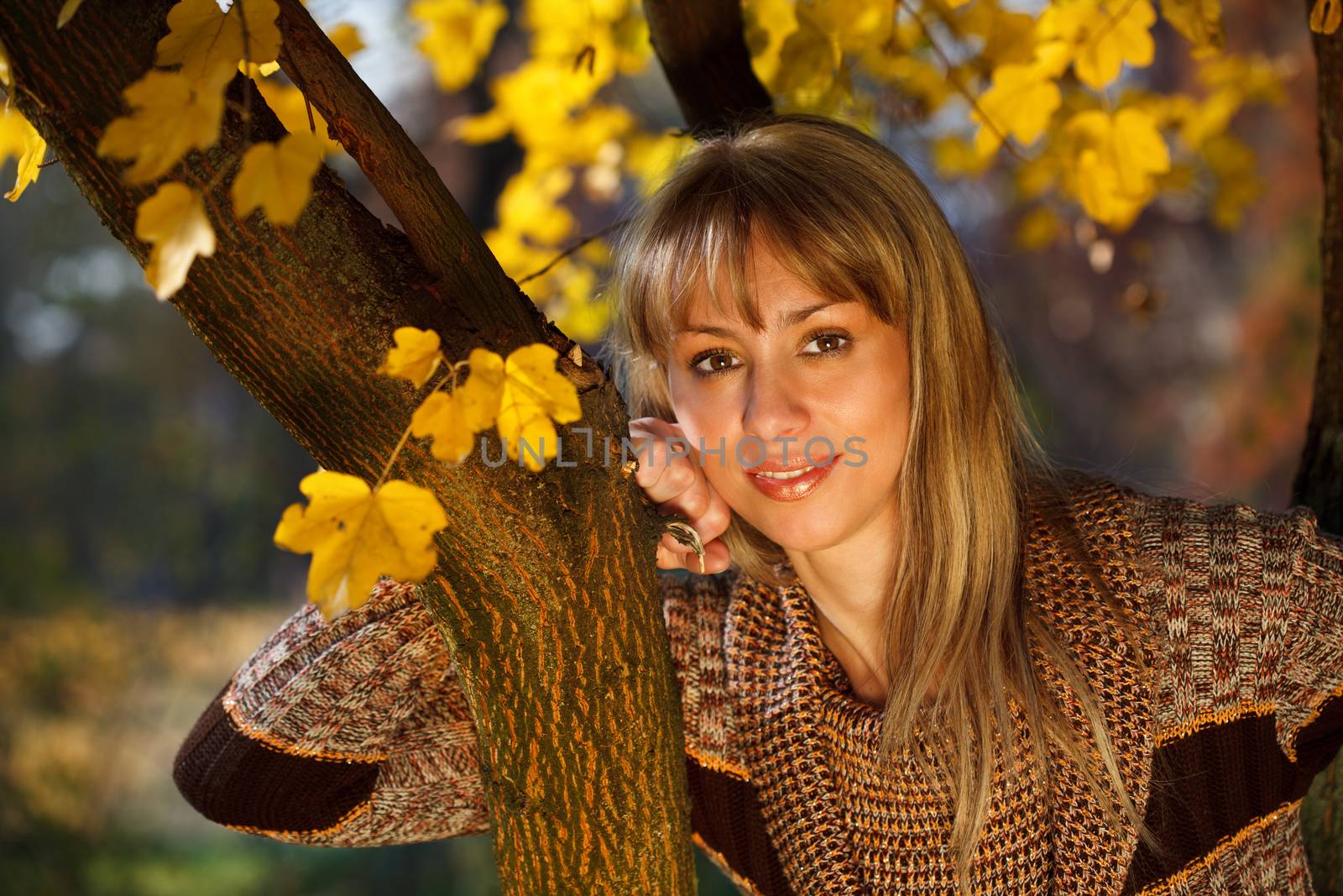 Beautiful woman in autumn fashion in nature