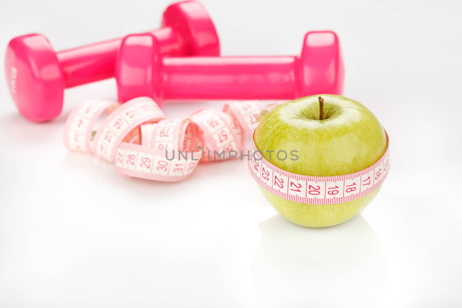 Green apple with measuring tape and Hand Weight