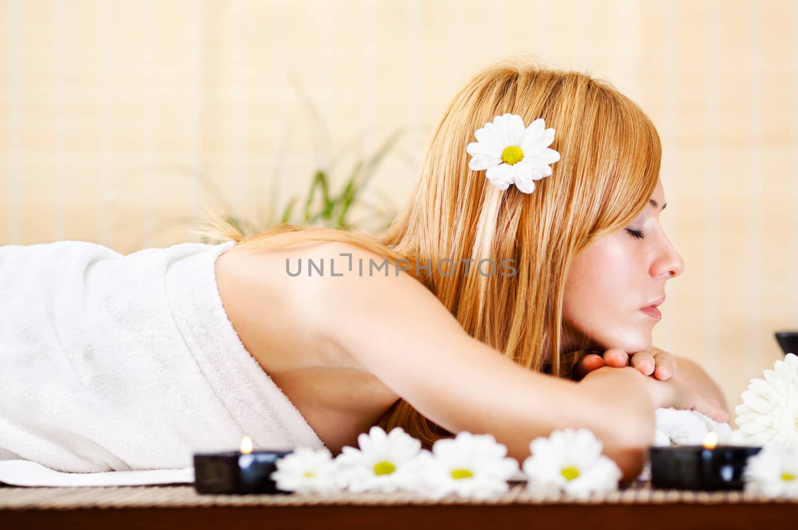 Young beautiful woman relaxing and enjoying at the spa center