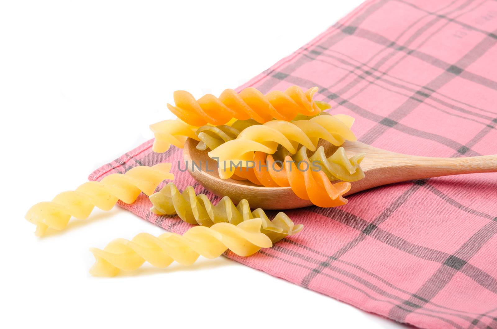 Uncooked italian pasta - three colors spirals. by Gamjai