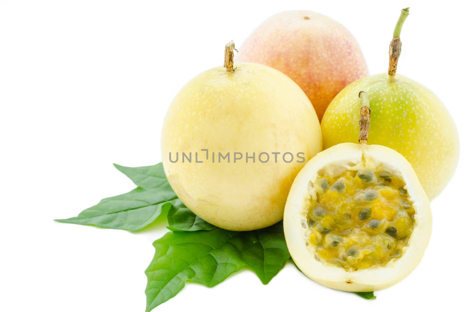 Yellow Passion fruit and green leaf. by Gamjai
