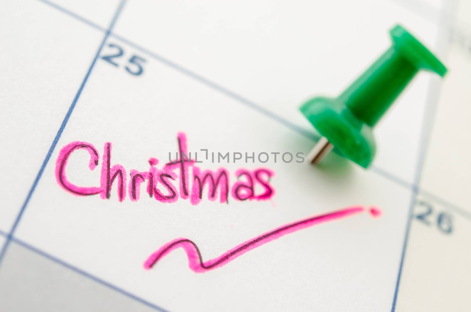 Pushpin on calendar with christmas. by Gamjai