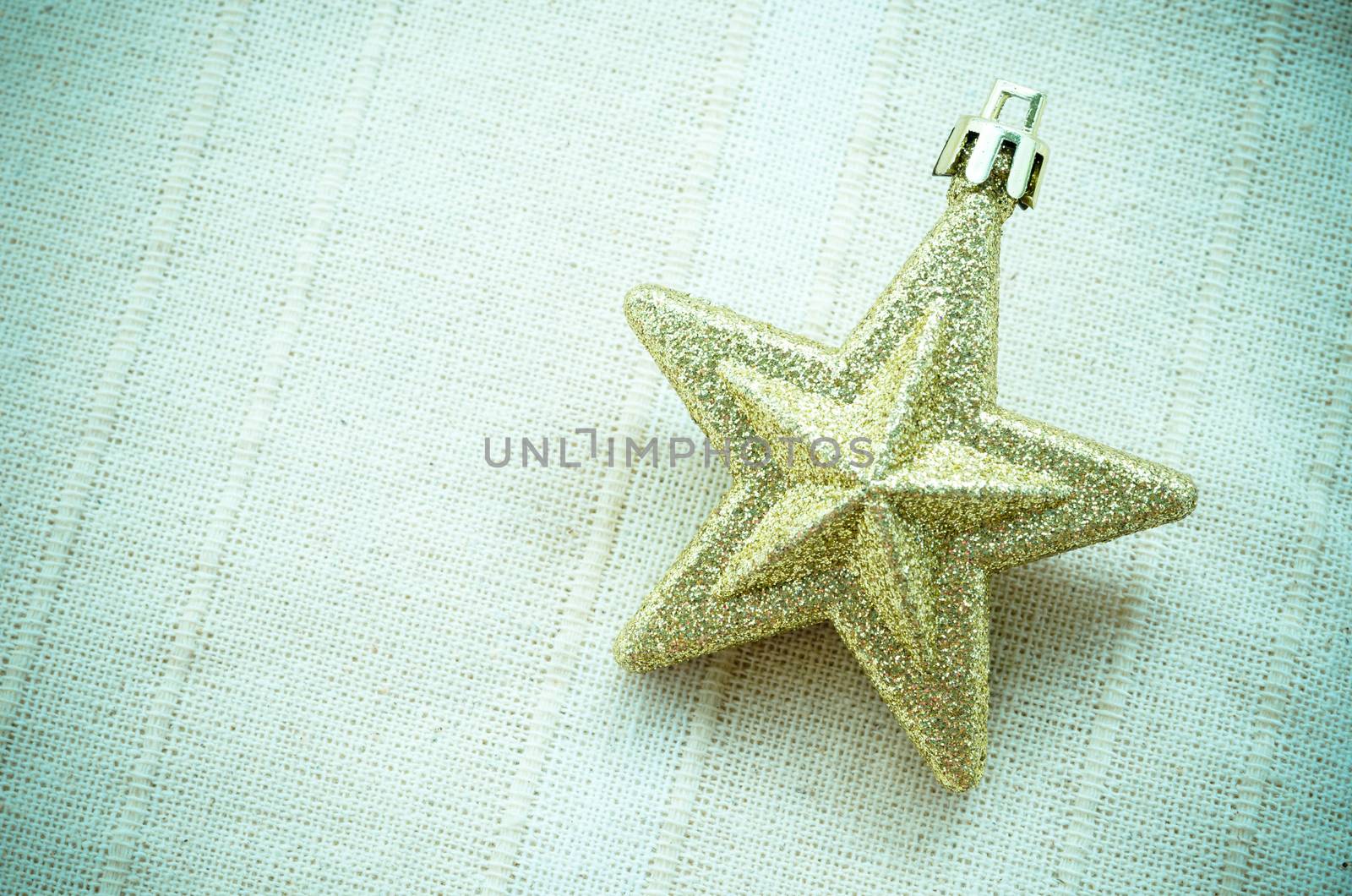 Golden Christmas star on tablecloth.