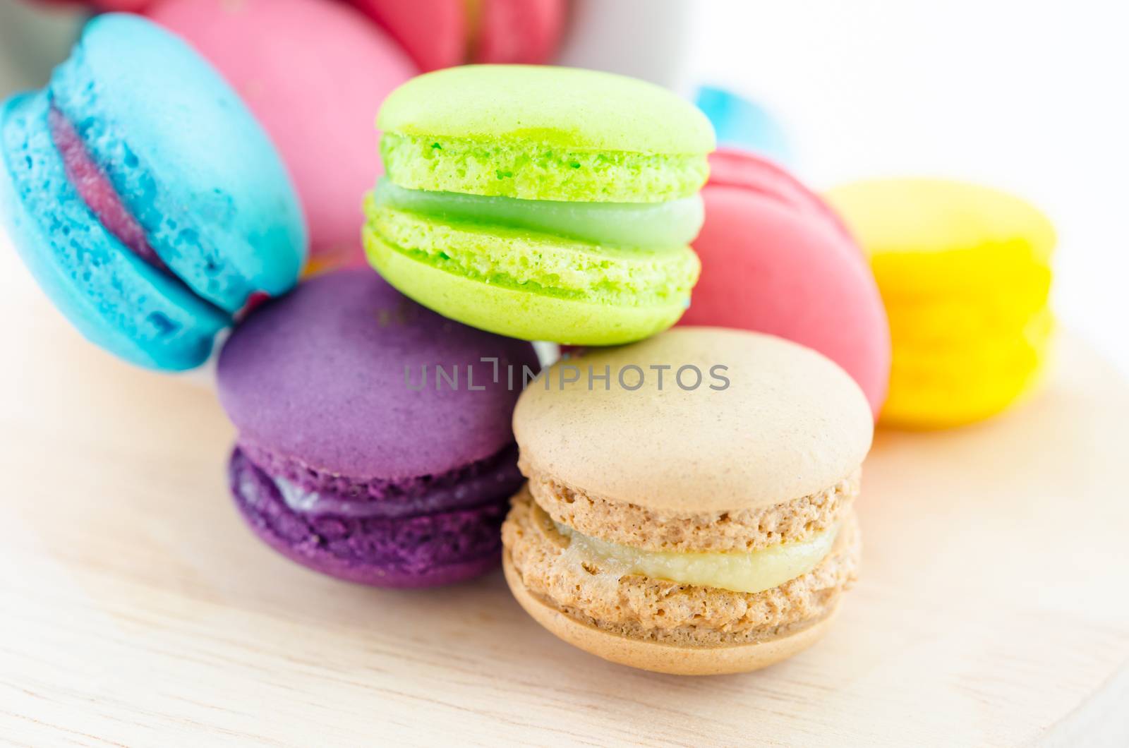 Colorful macaroons in white cup. by Gamjai