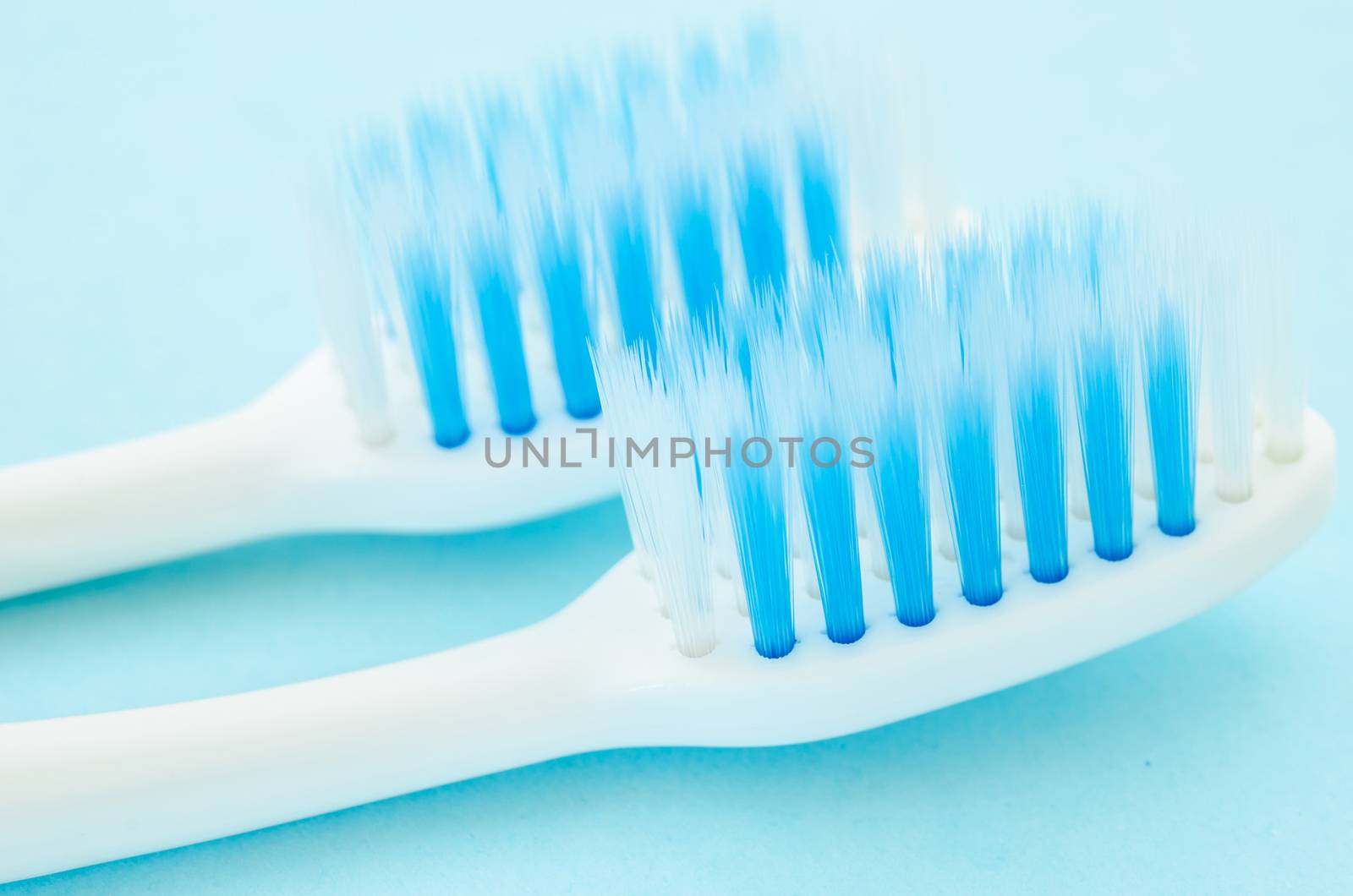 close up shot of toothbrush on blue background.