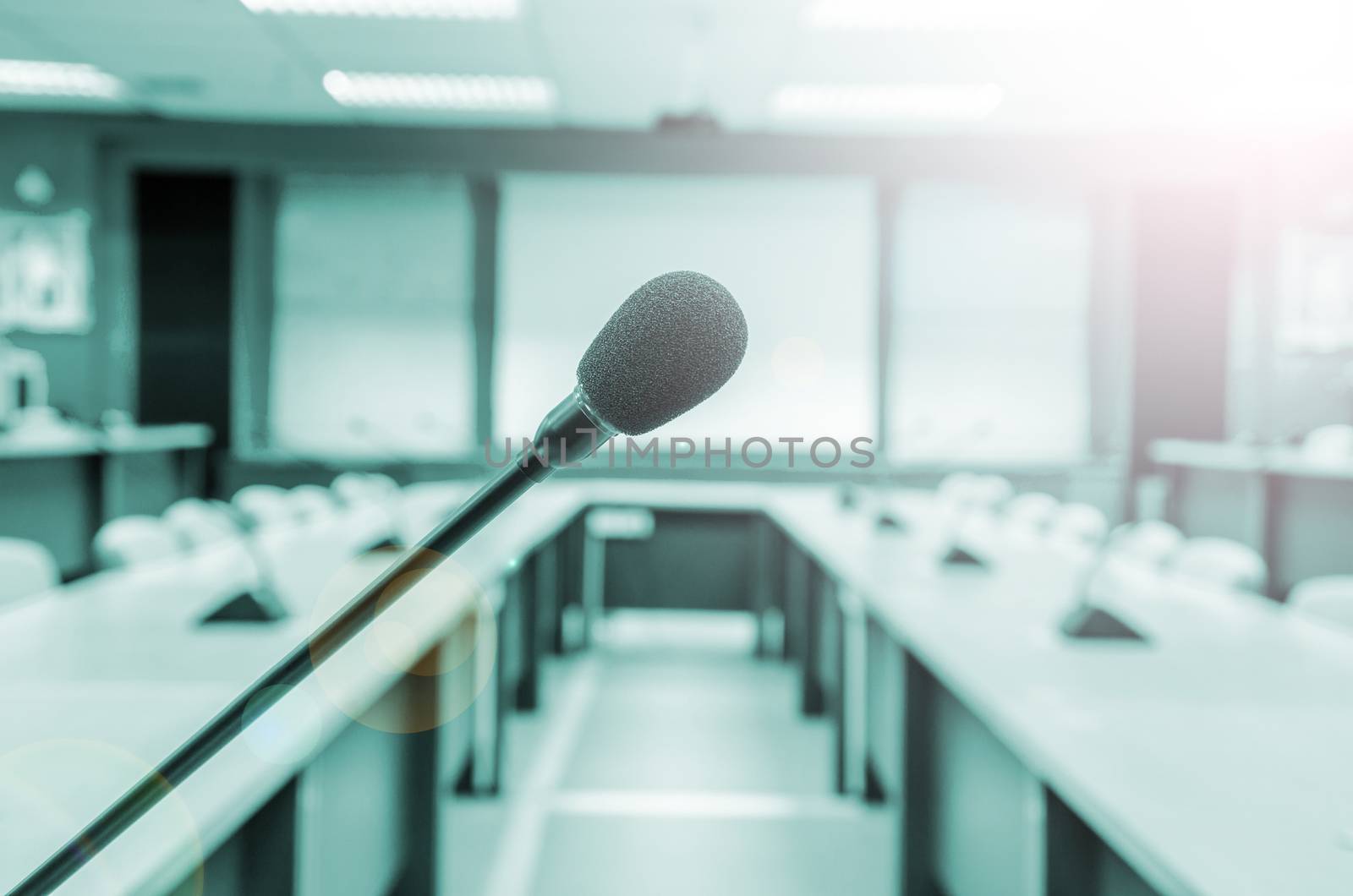 before a conference, the microphones in front of empty chairs in meeting room.