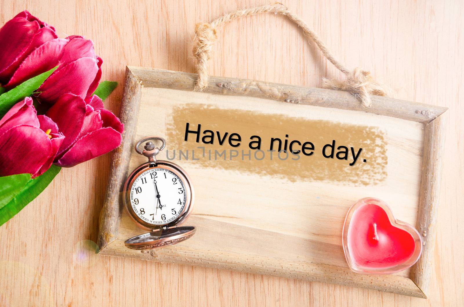 Have a nice day. Clock and red tulip with red candle heart shape on wooden background.