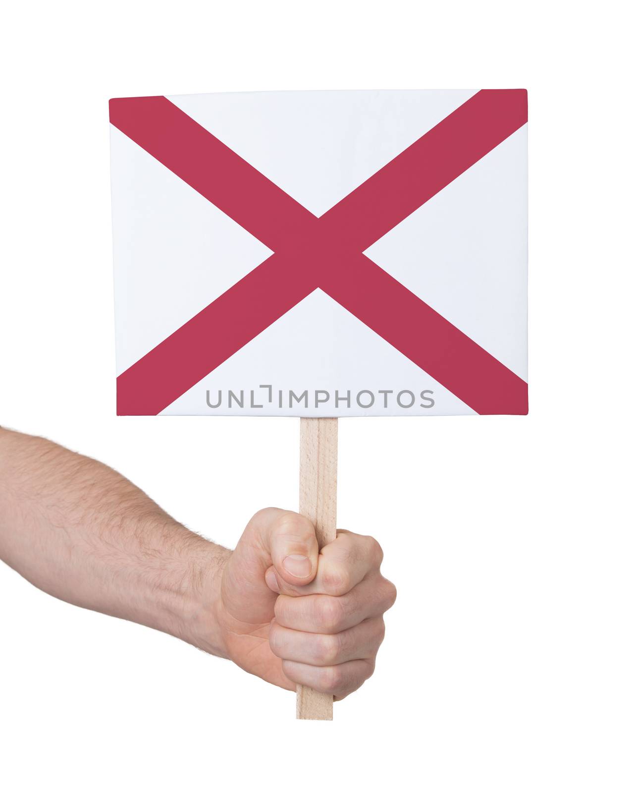 Hand holding small card, isolated on white - Flag of Alabama