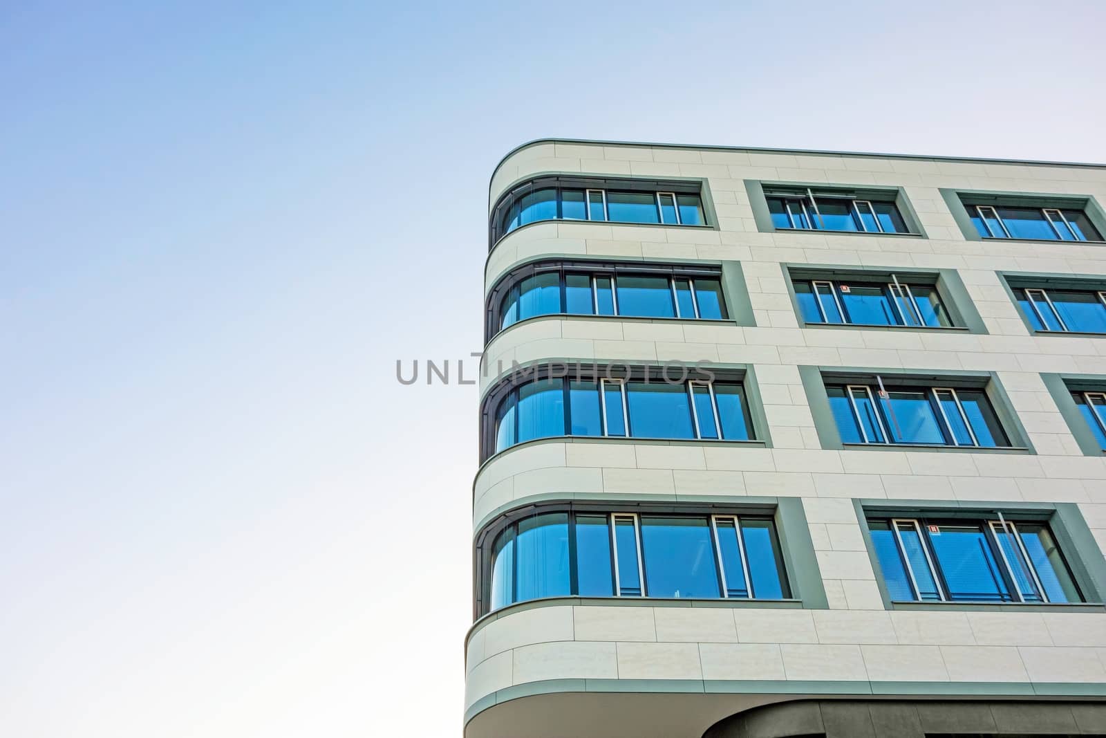 Detail of an modern office building, light blue sky