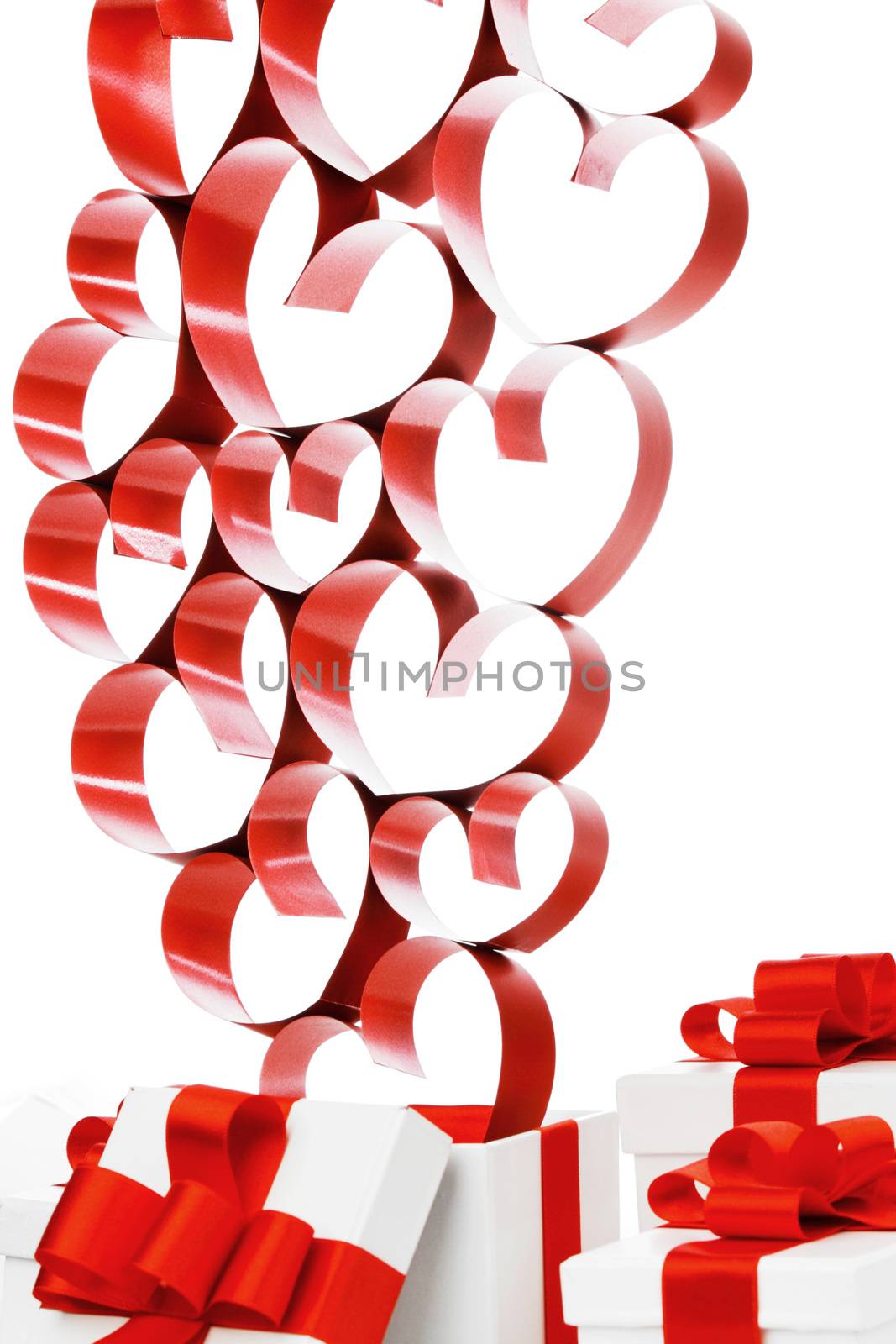 Gifts in white boxes with red ribbons and hearts isolated on white background