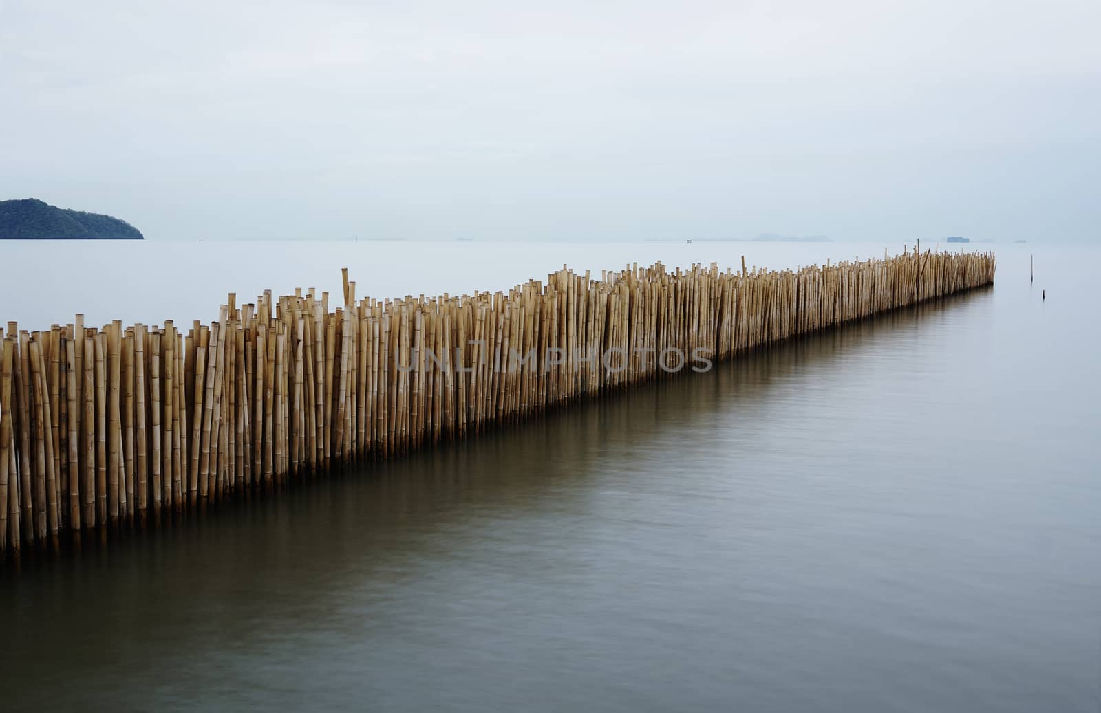 Found the bamboo partition in the beach of Phuket, this is use for separate the water from river to the sea, to make sure the water near by the beach was not pollution. Take it by long exposure.

