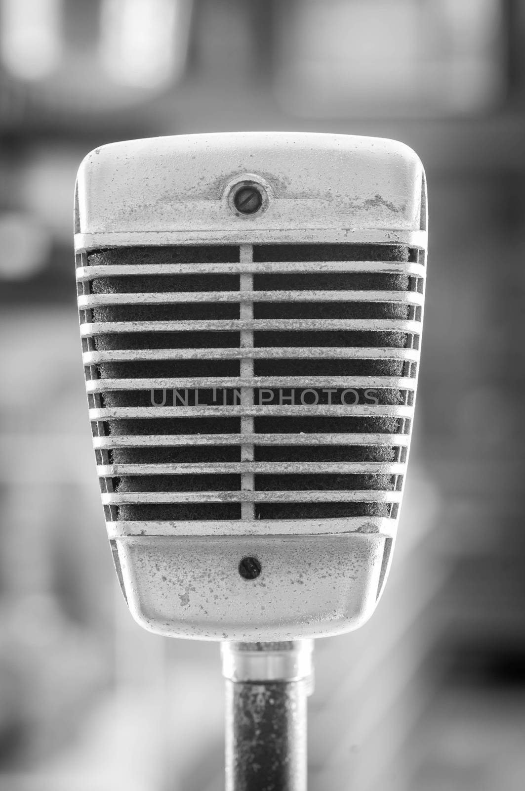 Retro microphone on blur background. Black and white color.
