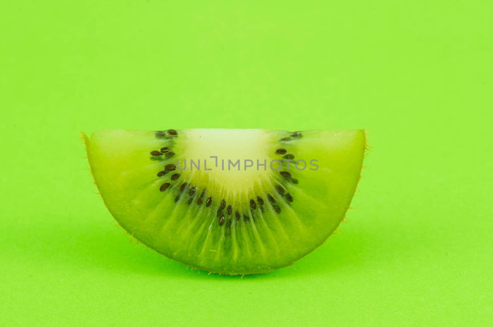 Kiwi fruit isolated on green background.