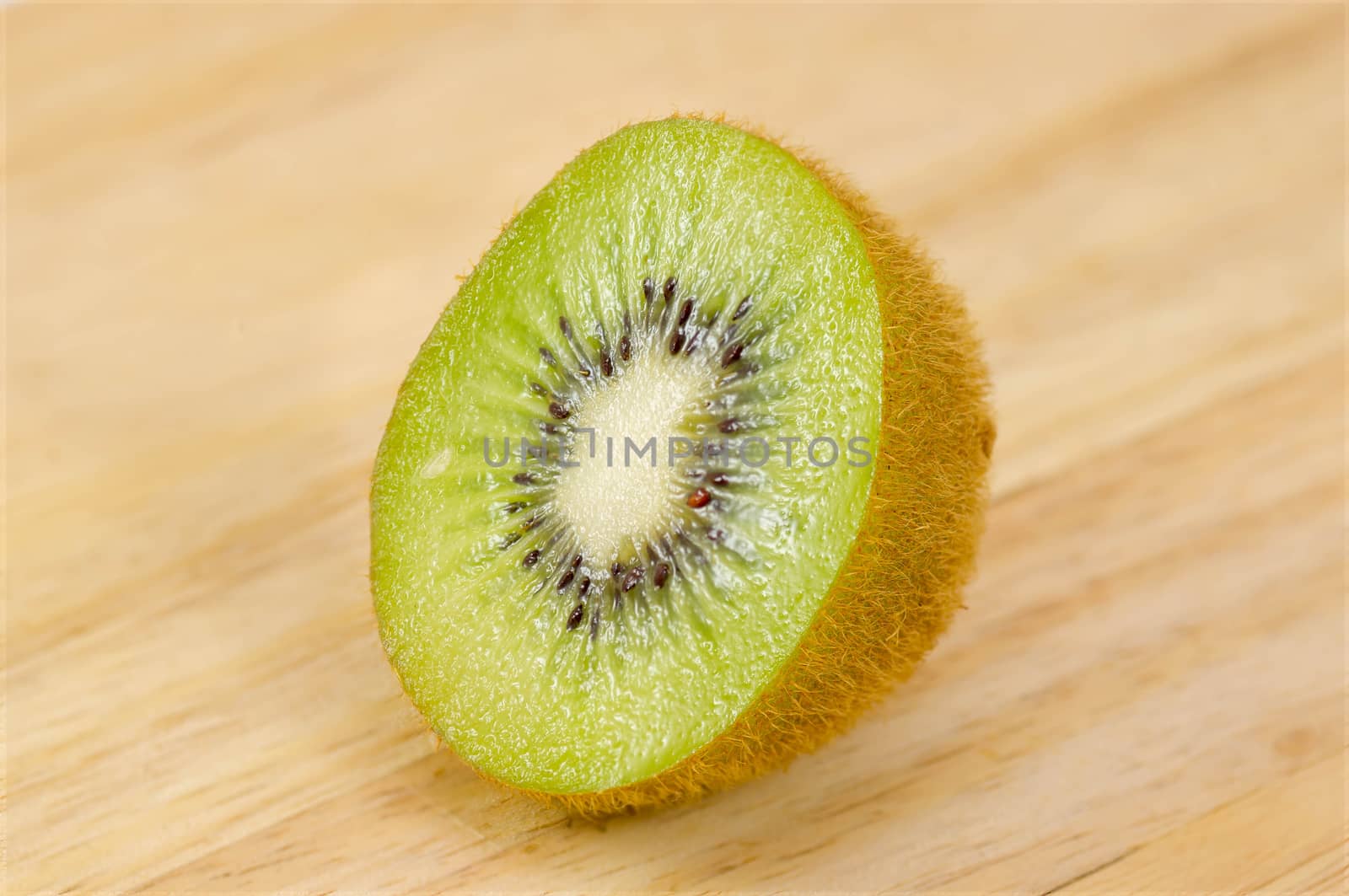 Kiwi fruit isolated on wooden background.