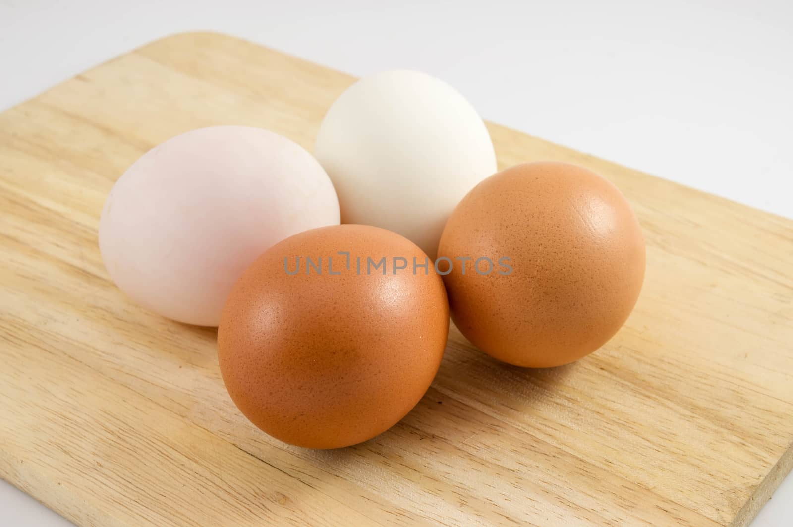 Eggs on wood background. by seksan44