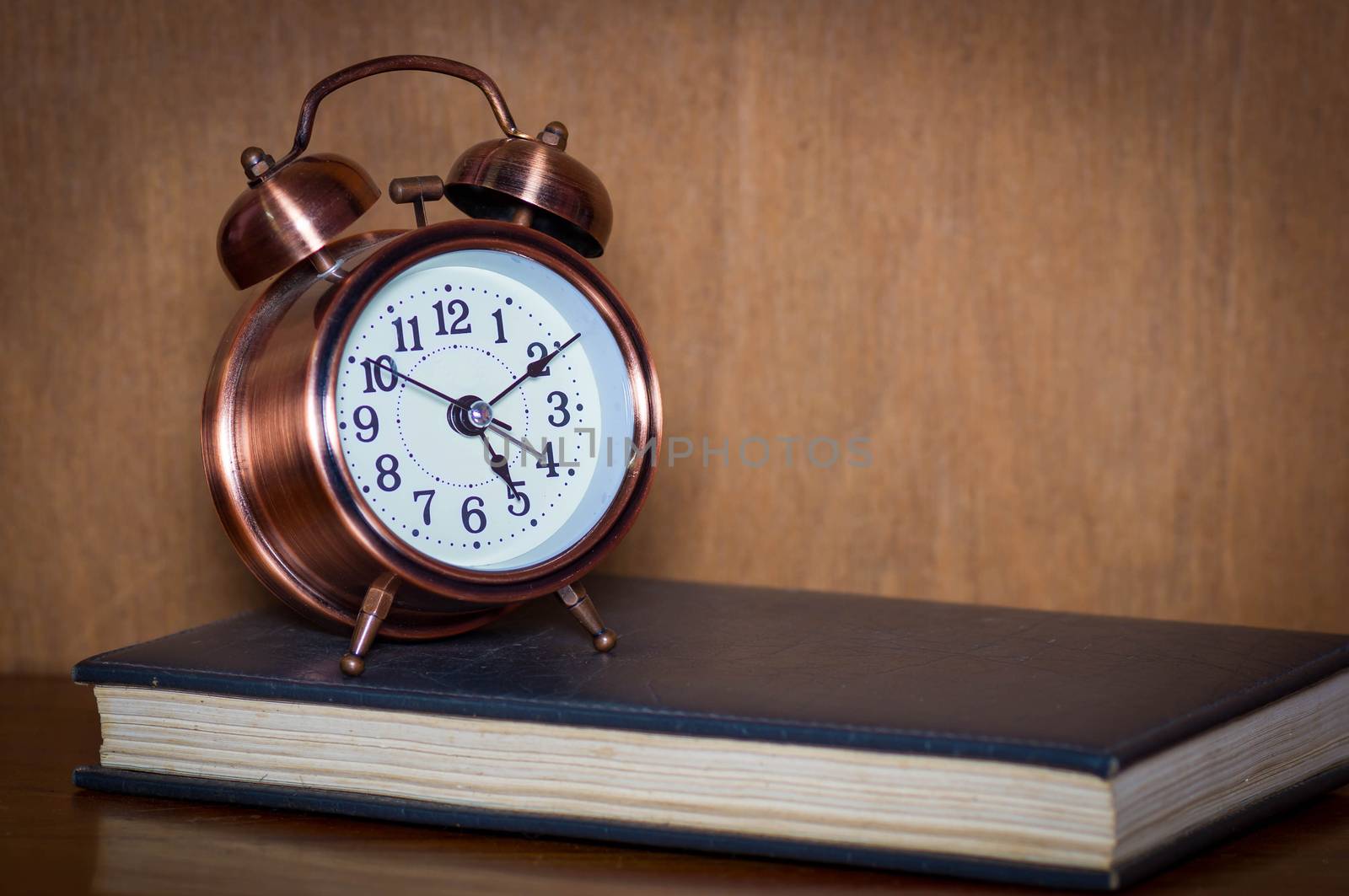 Retro alarm clock and book.