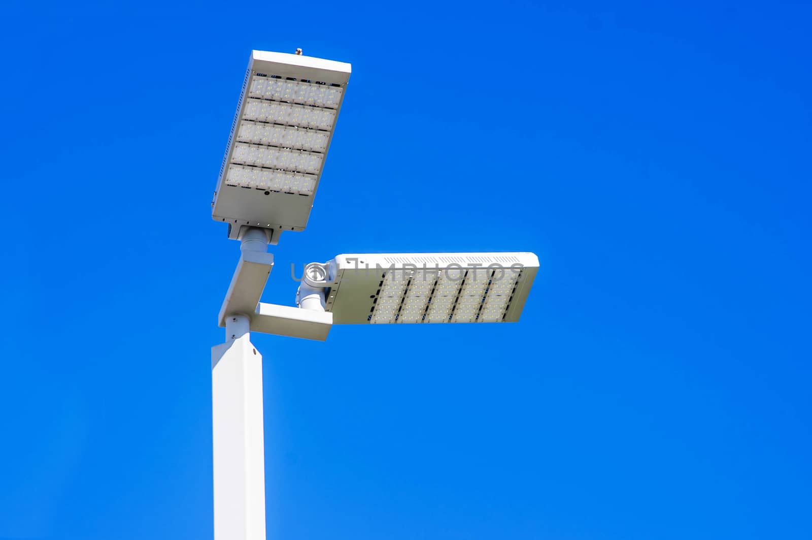 LED Street Lamps Affixed to an Iron Post Against a Deep Blue Sky Affixed to an Iron Post Against a Deep Blue Sky