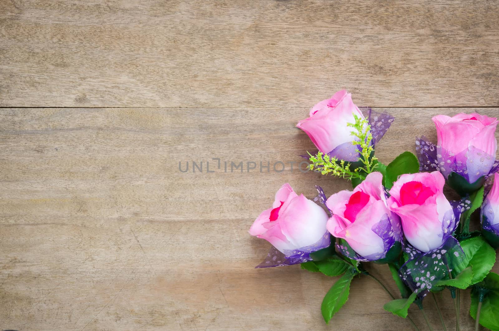Rose  on wooden table background.