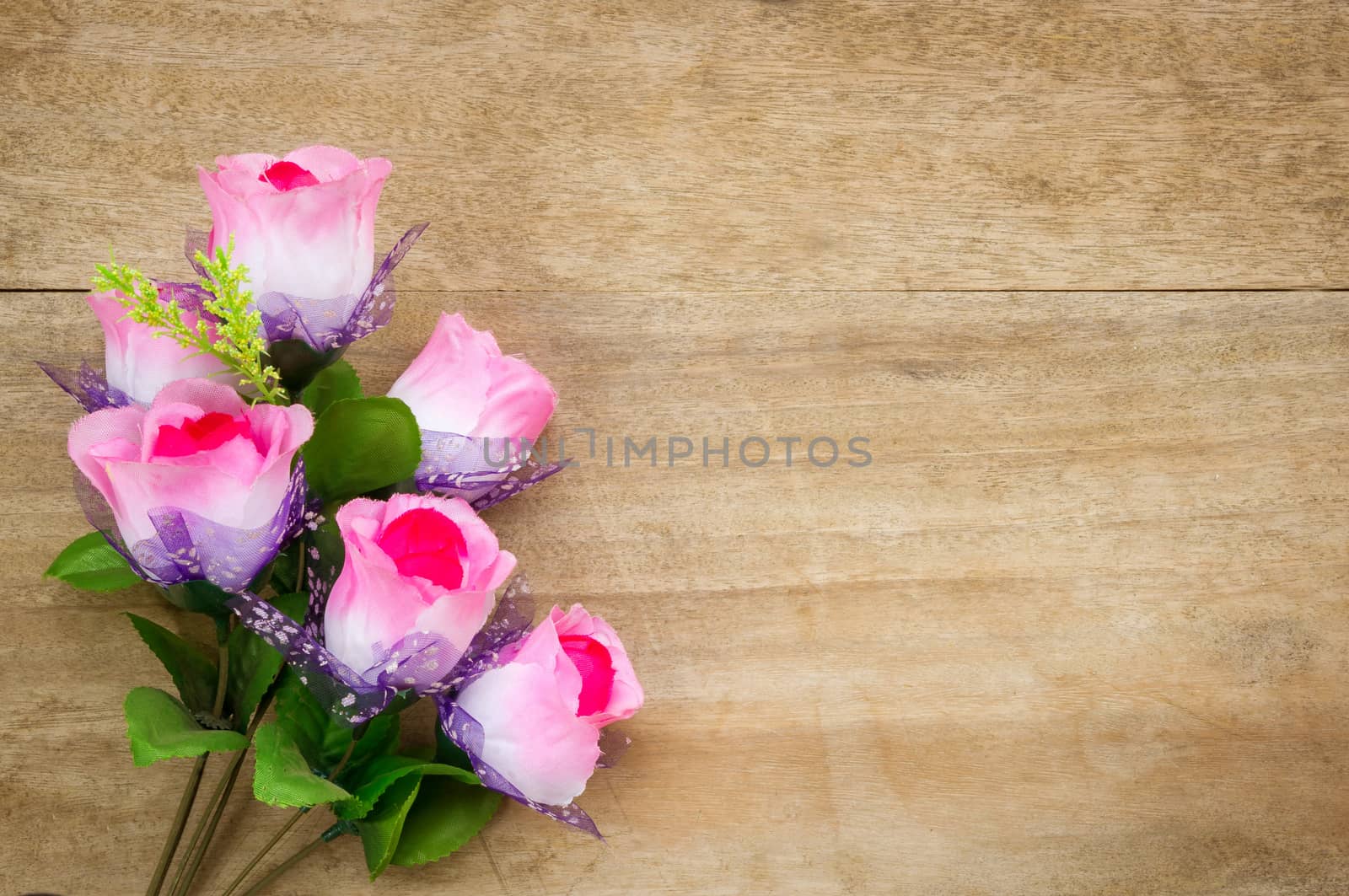 Rose  on wooden table background.