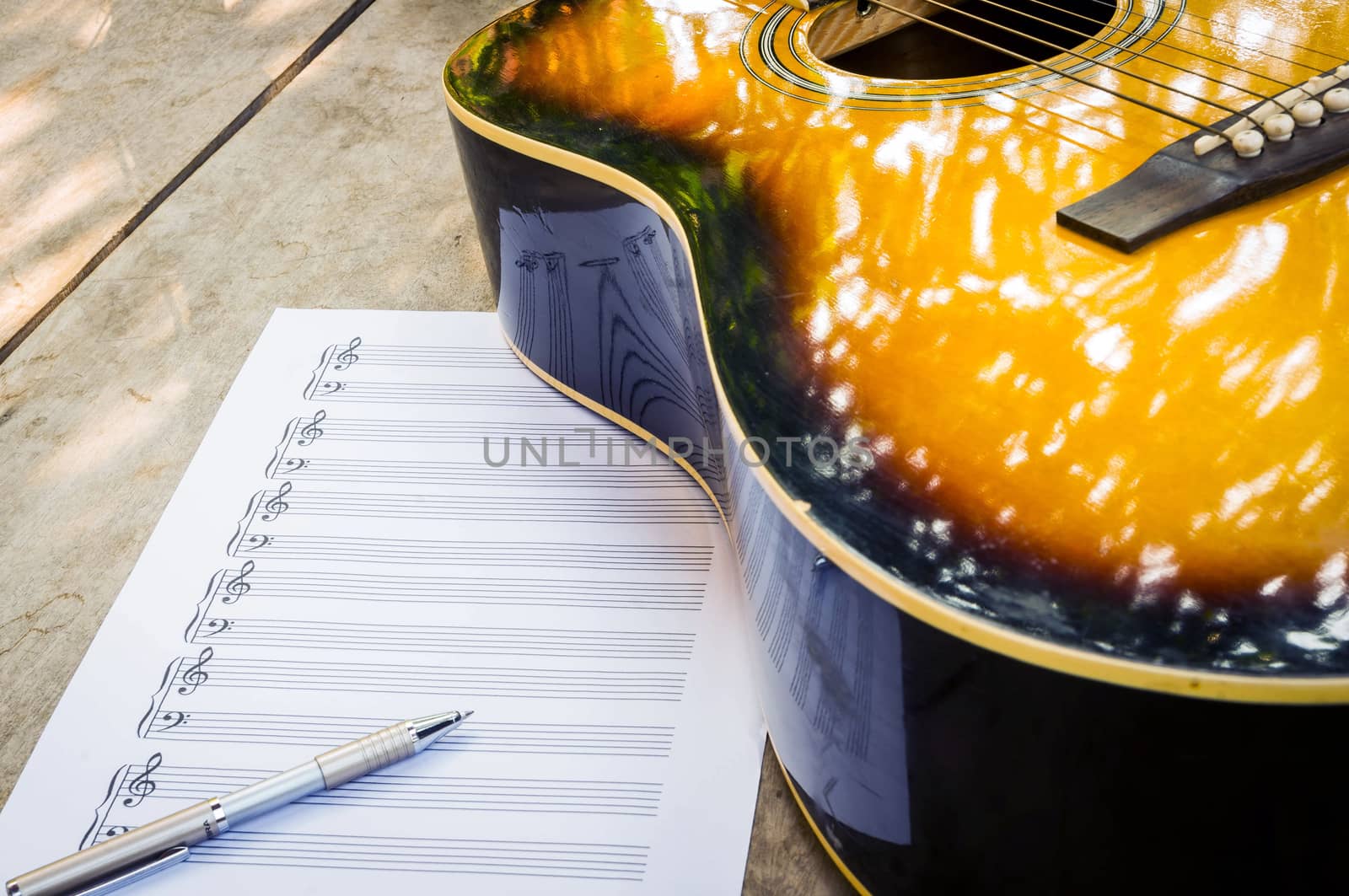 guitar and blank notebook with pen.
