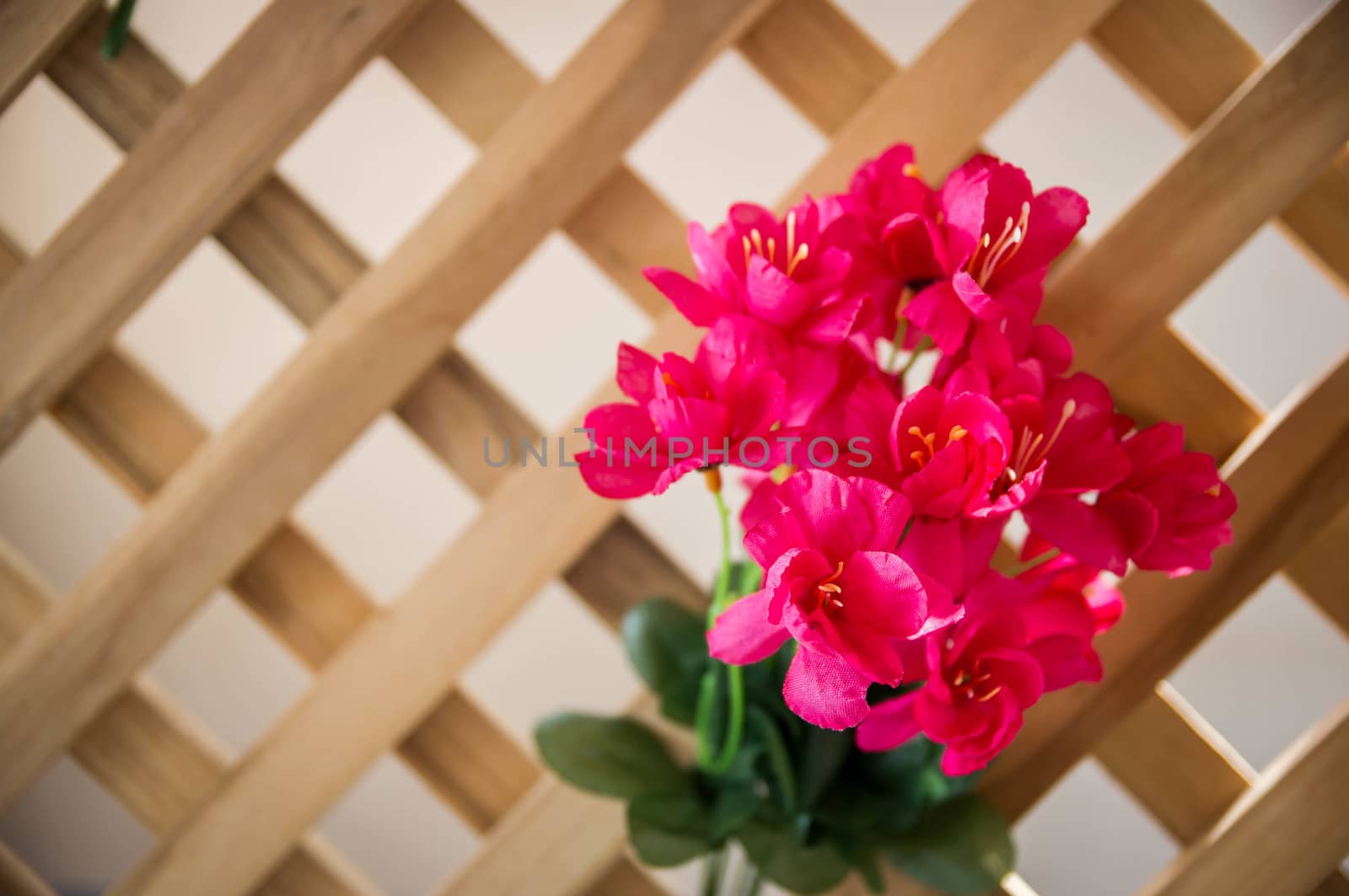 artificial flowers made from cloth on wood background.