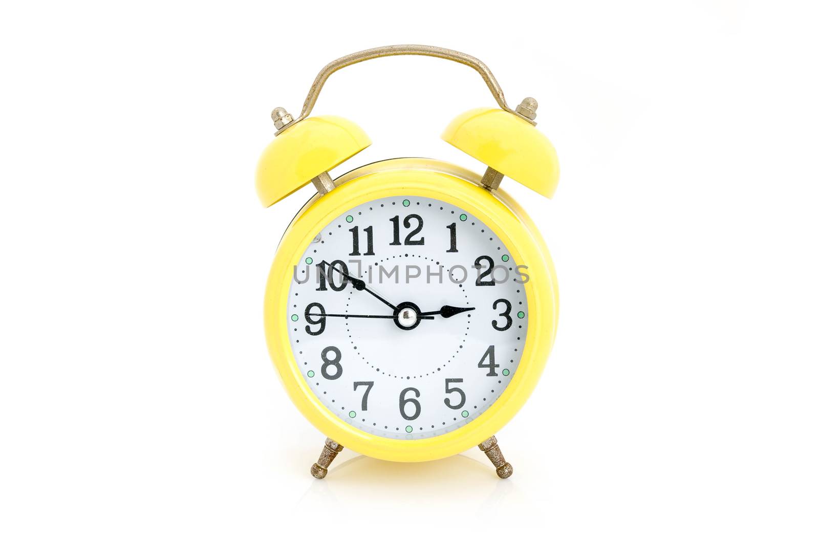 Old yellow alarm clock isolated on white background
