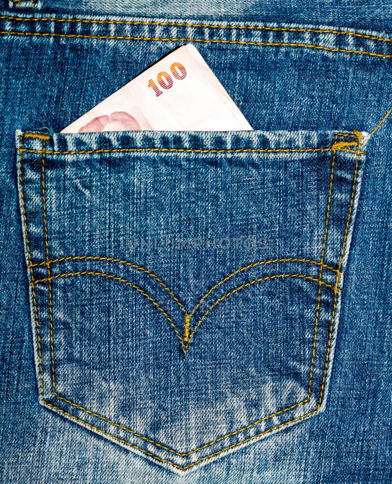 Close up blue jeans pocket and thai money.