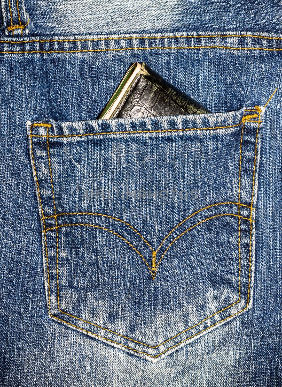 Close up blue jeans pocket with wallet.