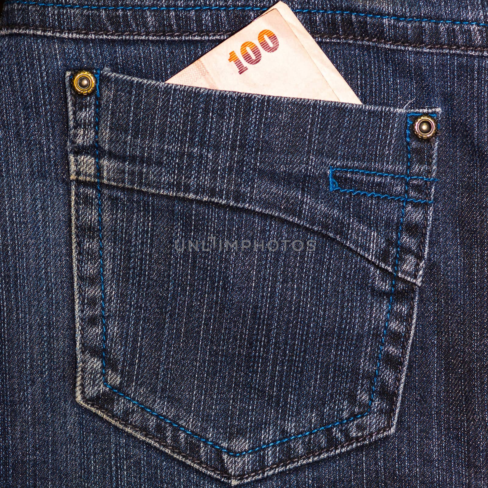 Close up blue jeans pocket and thai money.