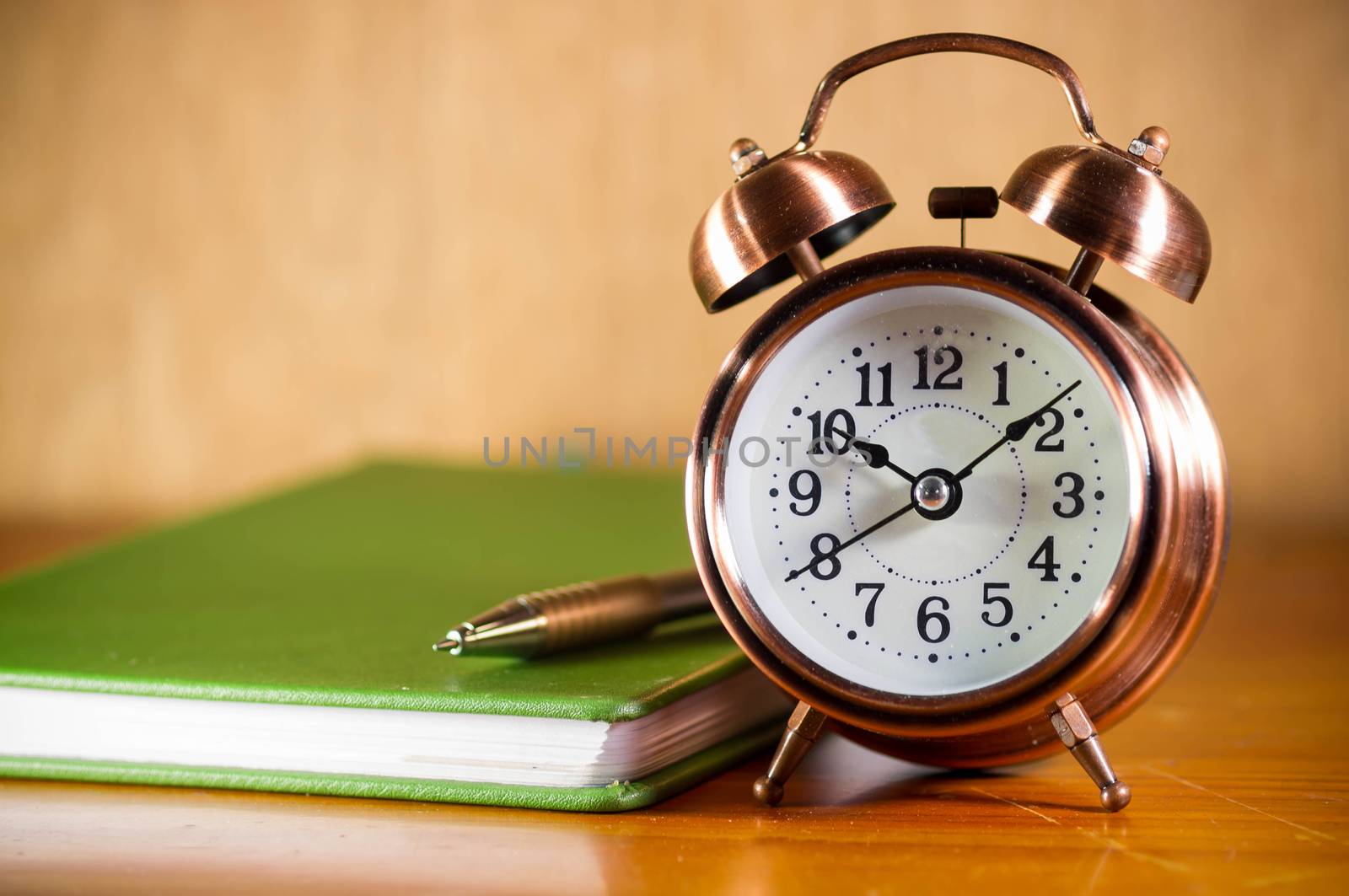 Retro alarm clock with books by seksan44