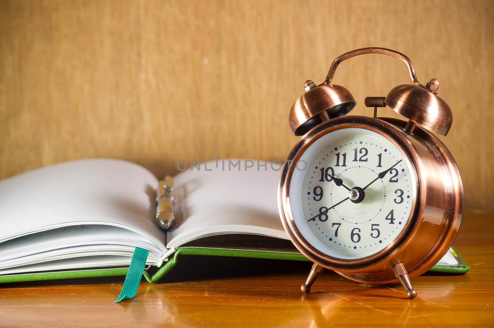 Morning with retro alarm clock and book.