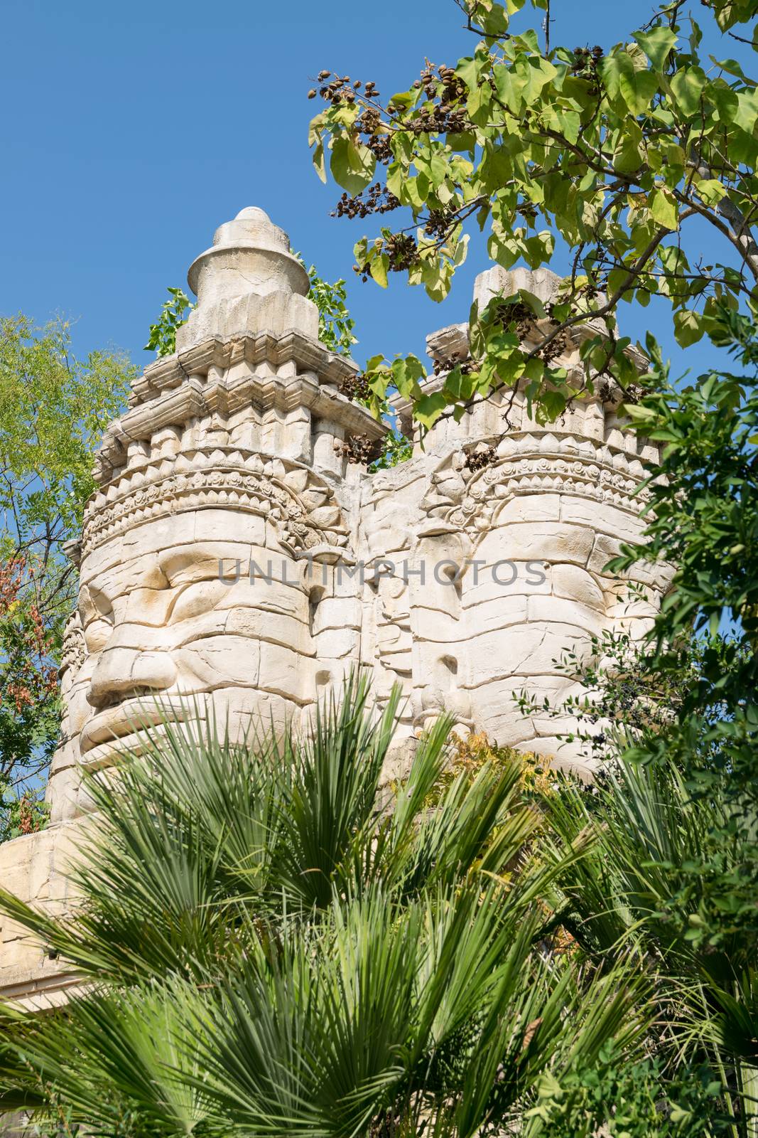 Stone faces of a temple in the forest.