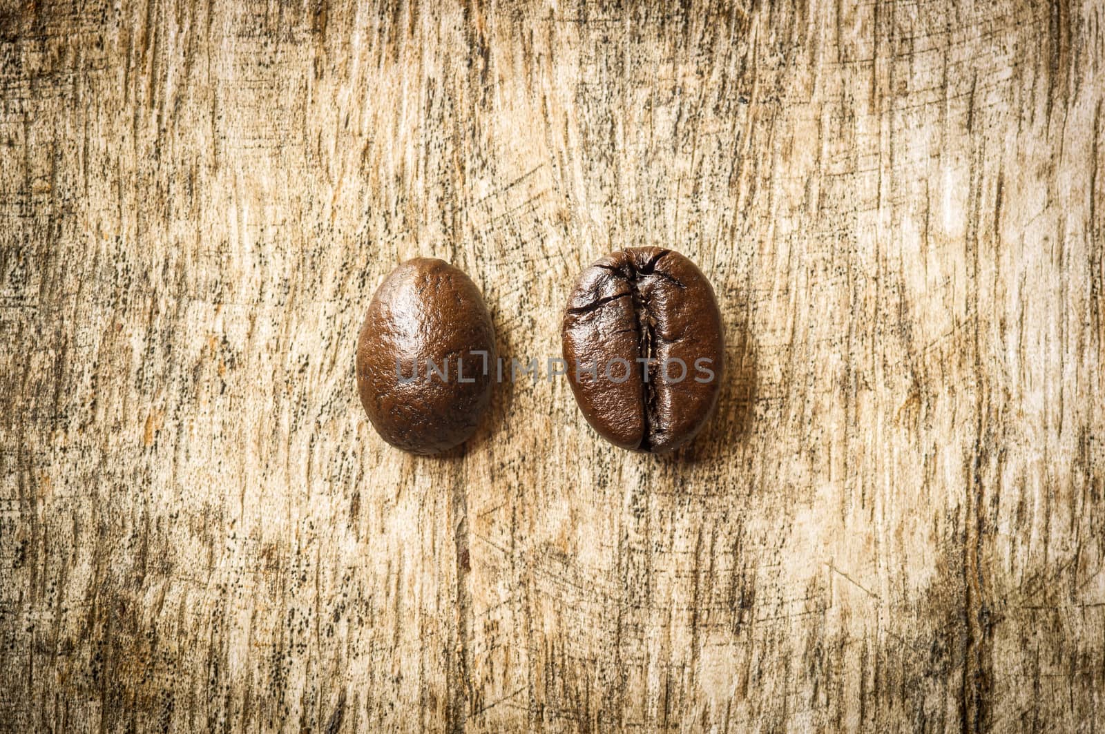 Coffee bean on grunge wooden background.