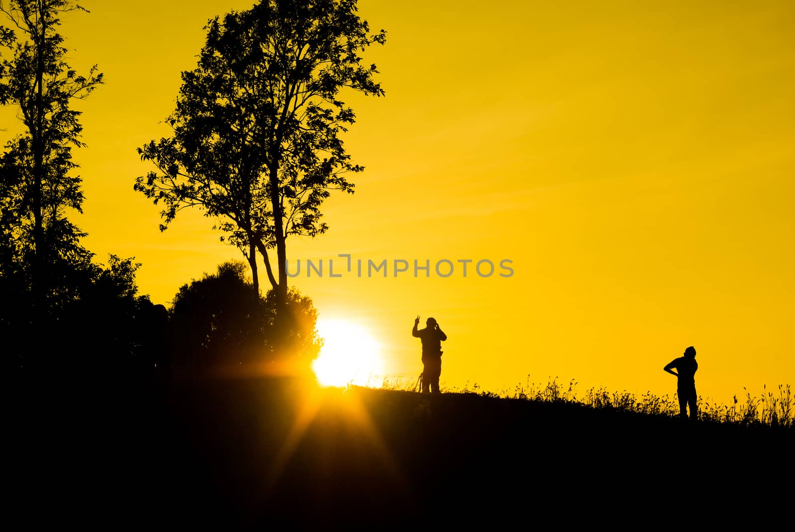 Silhouette sunrises and the man on moutain at Thailand.