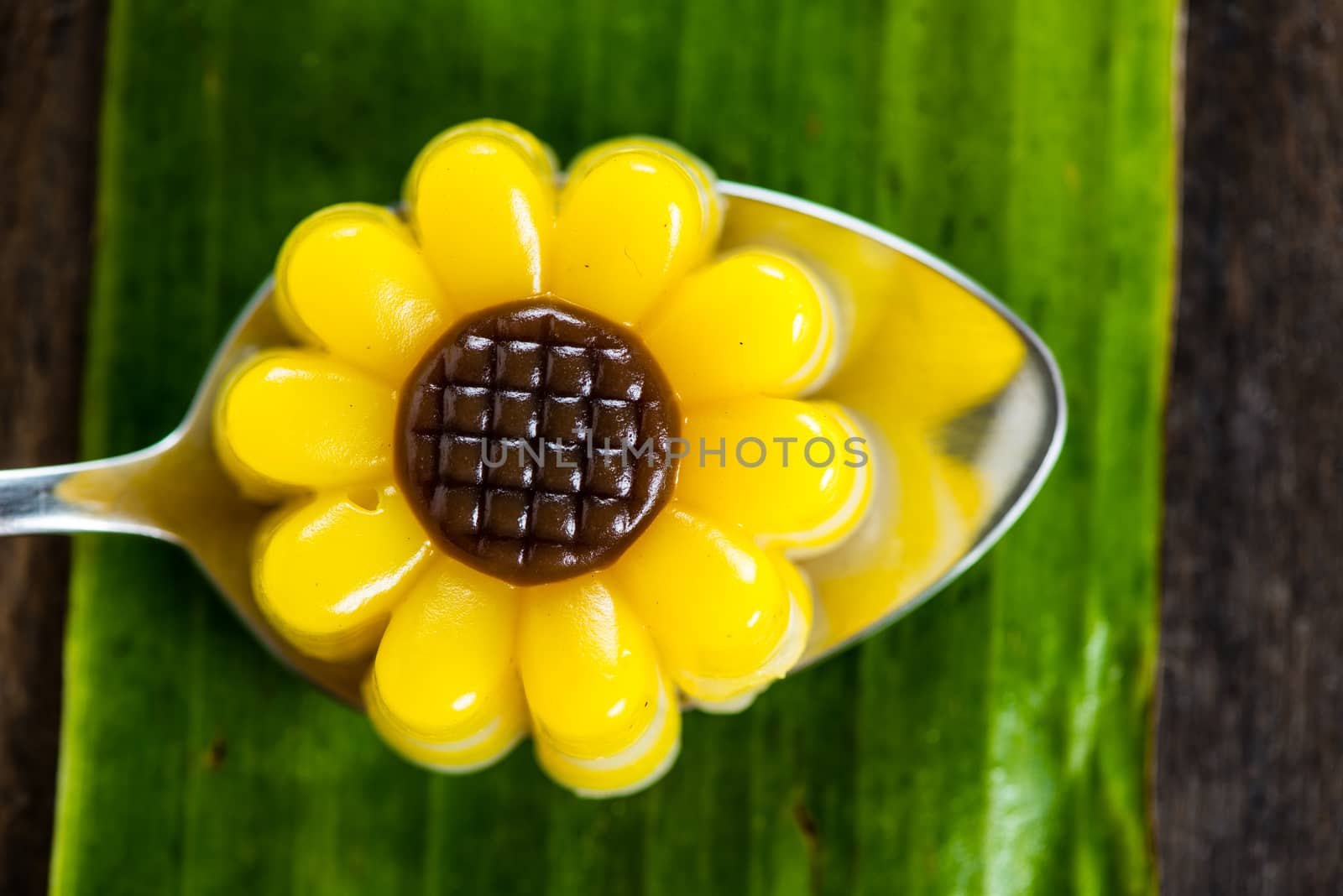 Yellow jelly dessert looking like a flower made with coconuts and pumpkin